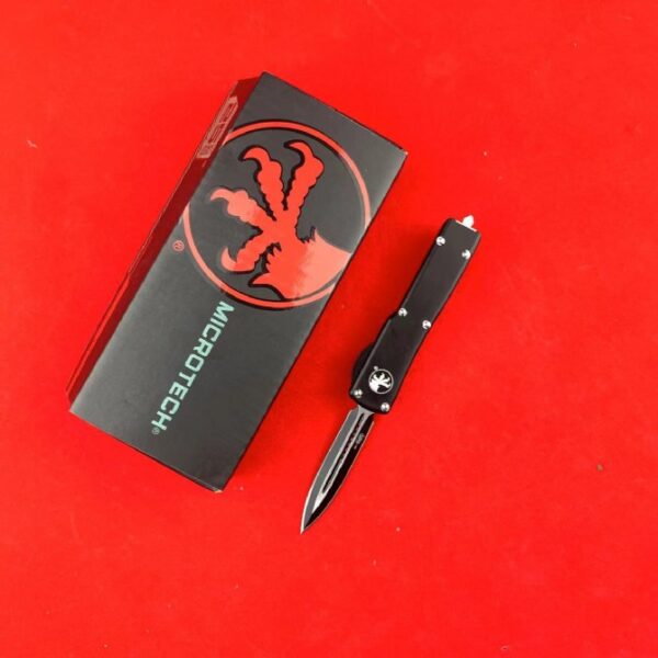 Microtech Mini UTX-85 OTF automatic knife with black handle and black double-edge blade
