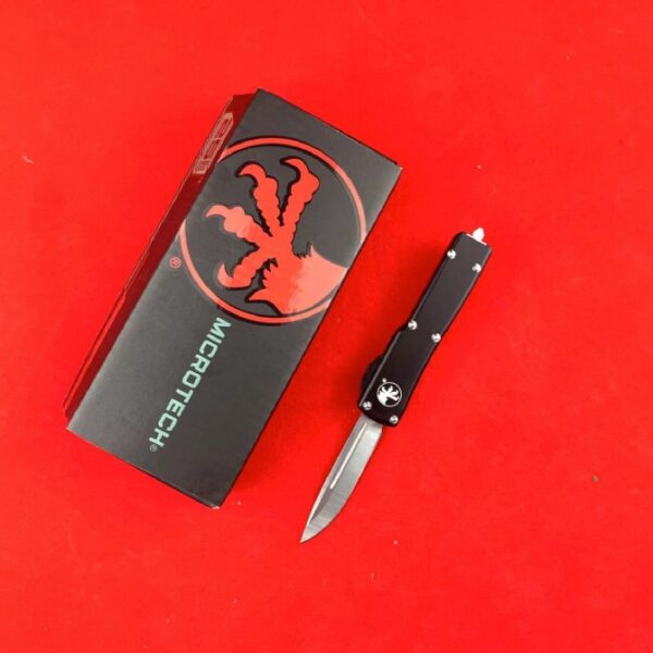 Microtech Mini UTX-85 OTF automatic knife with black handle and single-edge blade