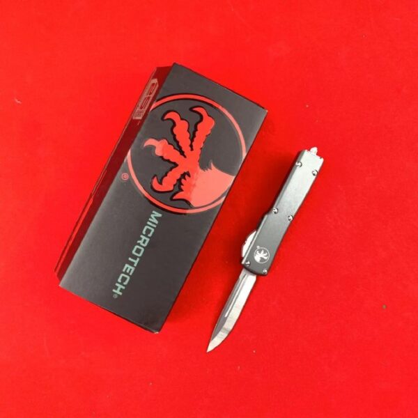 Microtech Mini UTX-85 OTF automatic knife with gray handle and single-edge blade