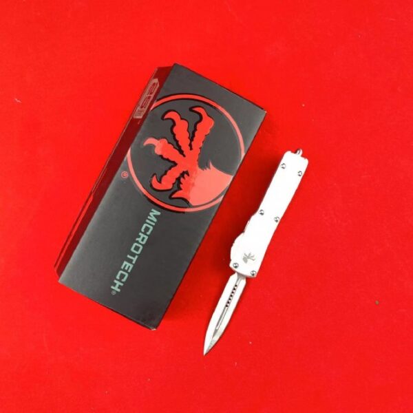 Microtech Mini UTX-85 OTF automatic knife with white handle and double-edge dagger blade