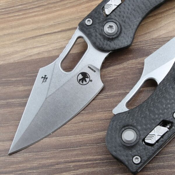 Blade detail of the Microtech Stitch RAM-LOK folding knife with a carbon fiber handle