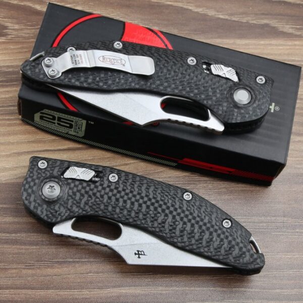 Folded view of the Microtech Stitch RAM-LOK folding knife with a carbon fiber handle