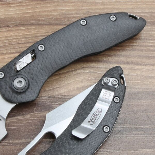 Handle detail of the Microtech Stitch RAM-LOK folding knife showing the carbon fiber handle texture