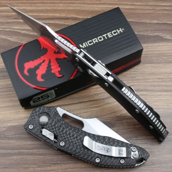 Spine view of the Microtech Stitch RAM-LOK folding knife showing the carbon fiber handle