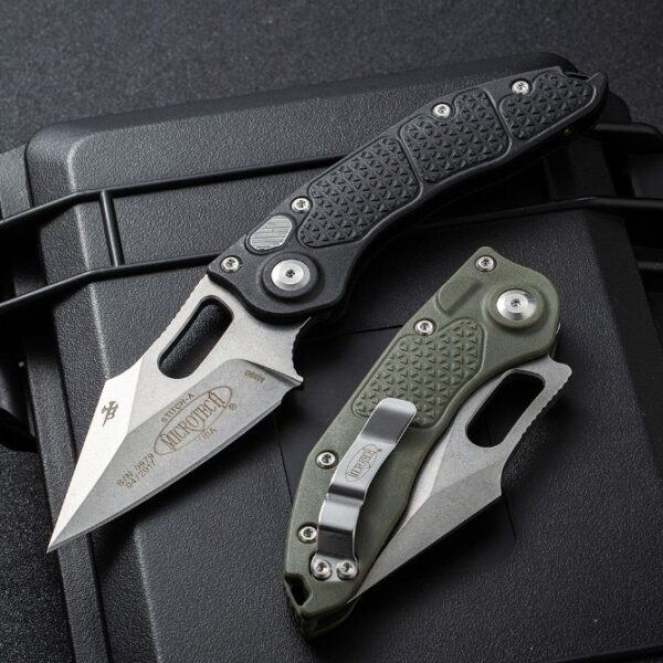 Microtech Stitch side-opening automatic knives displayed with black and green handles for color comparison