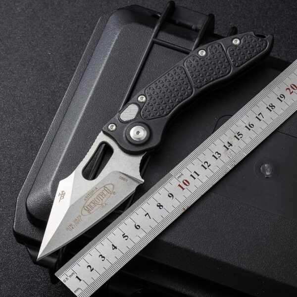 Microtech Stitch side-opening automatic knife with black handle showing blade length and overall size