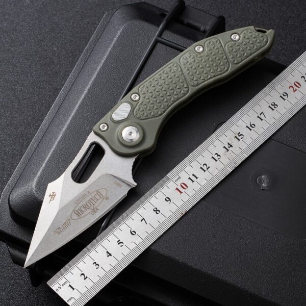 Microtech Stitch side-opening automatic knife featuring a green handle with full size measurements