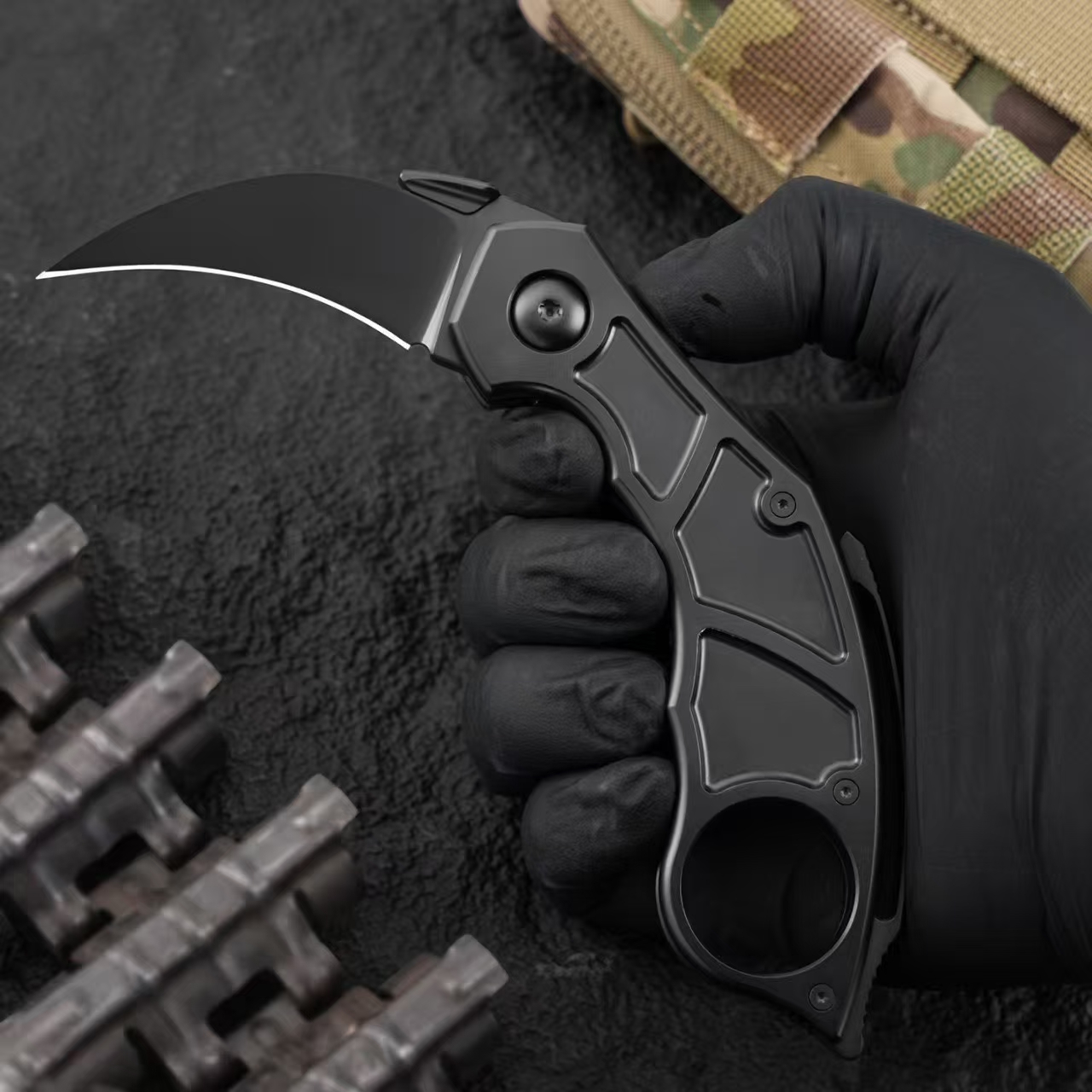 Handheld view demonstrating grip and finger ring of Quartermaster QSE-14 Murtaugh folding karambit knife