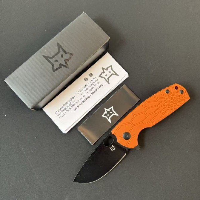 FOX FX-604 folding knife with orange FRN handle and black coated blade displayed open