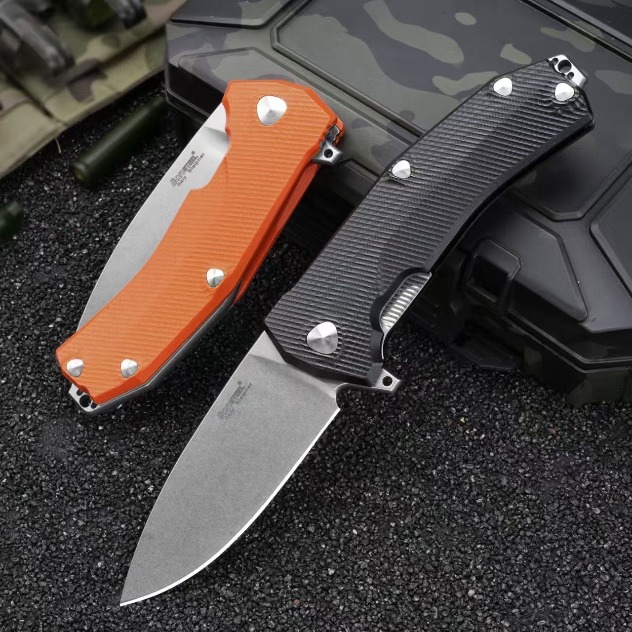 LionSteel Sleeper folding knife with black G10 handle deployed next to orange handle version in folded position