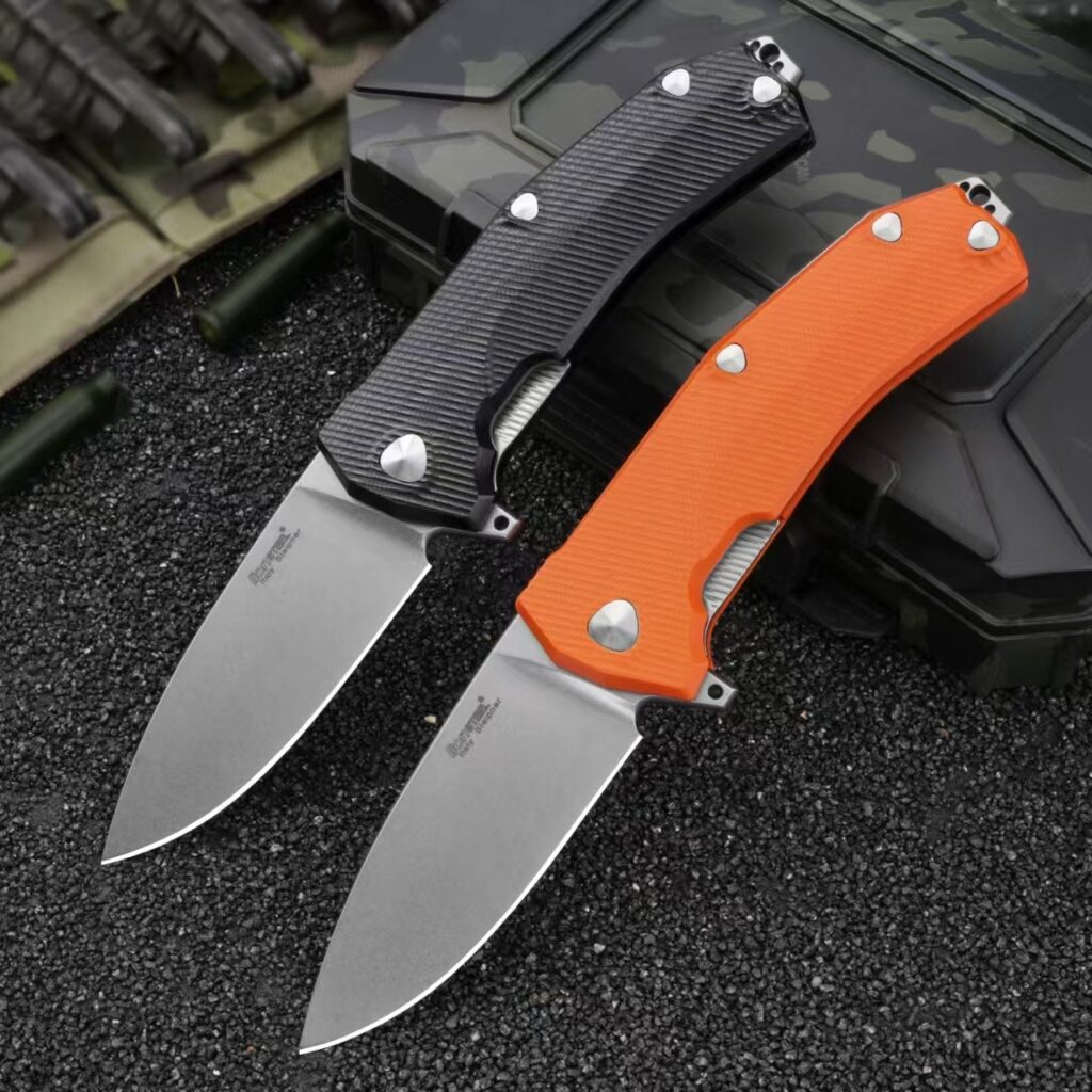 LionSteel Sleeper folding knives with stonewashed blades and black and orange G10 handles shown deployed from the front