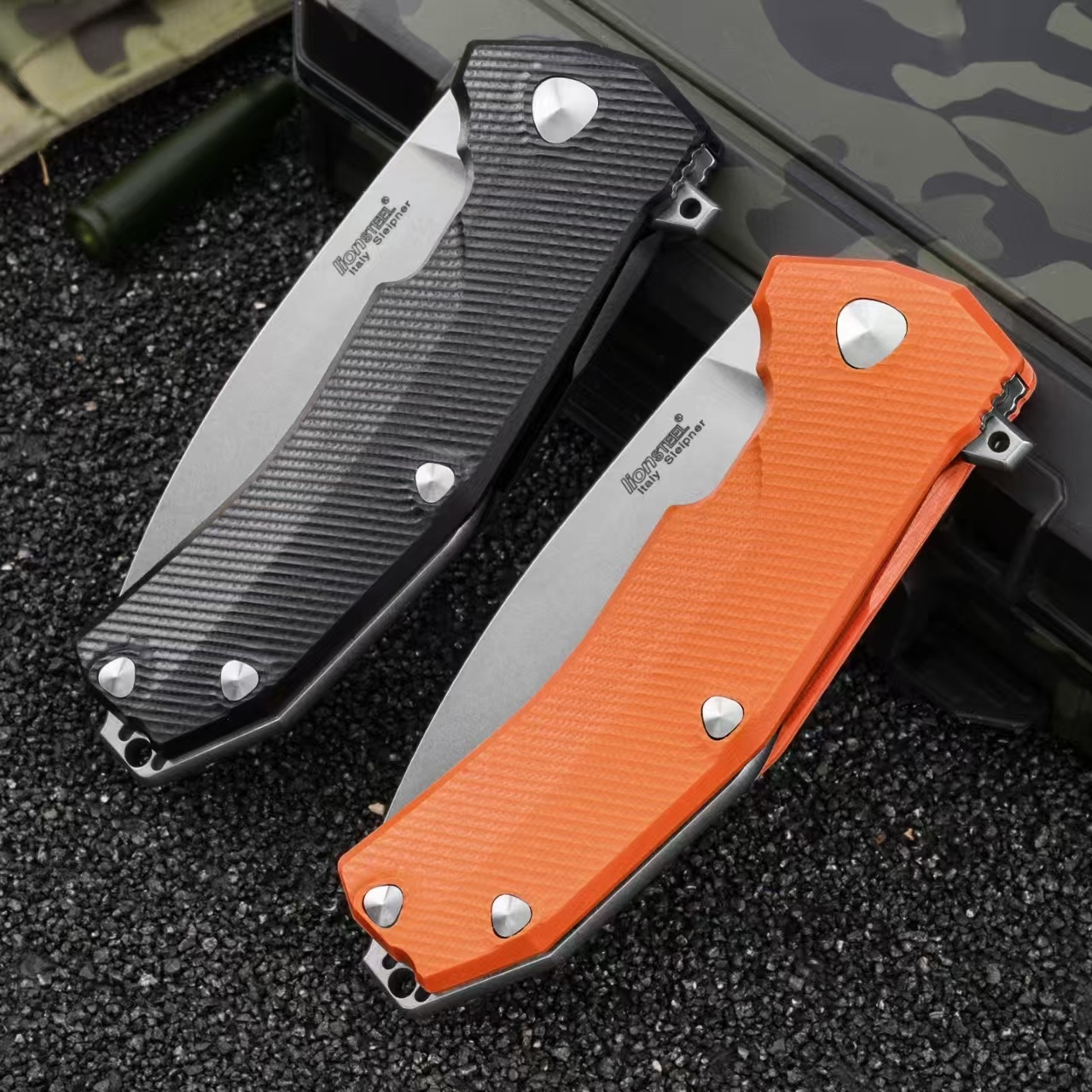 LionSteel Sleeper folding knives with black and orange G10 handles shown folded side by side