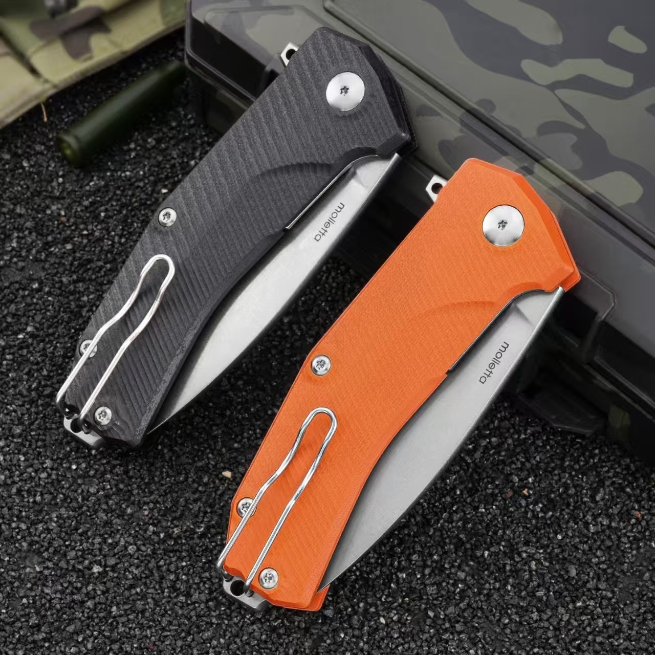 Rear view of LionSteel Sleeper folding knives with black and orange G10 handles in folded position
