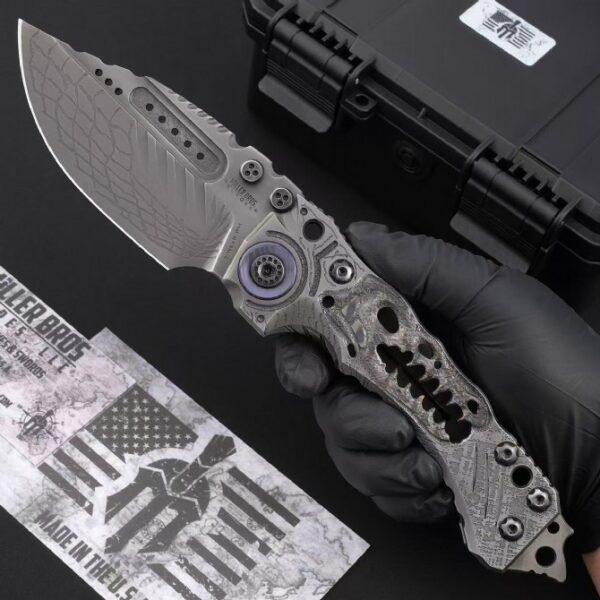 Handheld view of Miller Bros T1 Series Jurassic tactical folding knife in deployed position